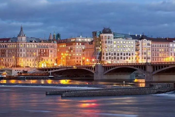 The embankment of the Vltava River and the famous Dancing House, Prague, Czech Republic.