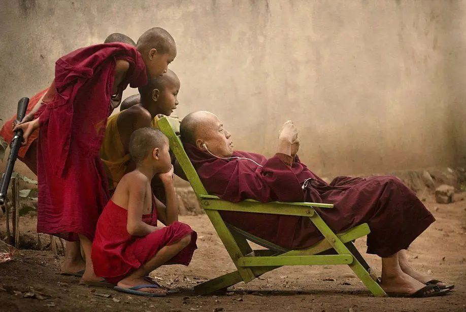 Young monks gathered to gaze at the iPod, Malaysia