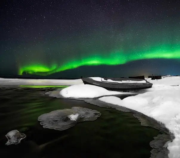 Polar lights in the Murmansk region, the city of Monchegorsk, the Moncha river