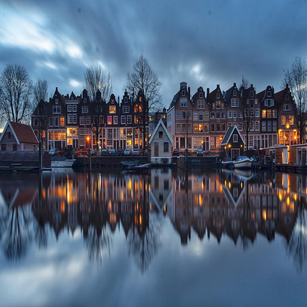 Evening Amsterdam in the reflection of the river, Netherlands