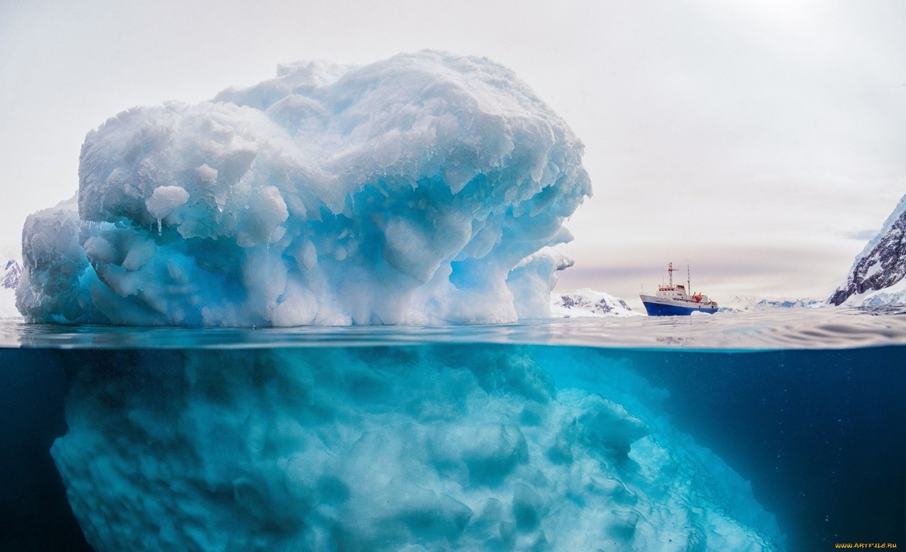 Three-ton ship on the background of a giant iceberg.