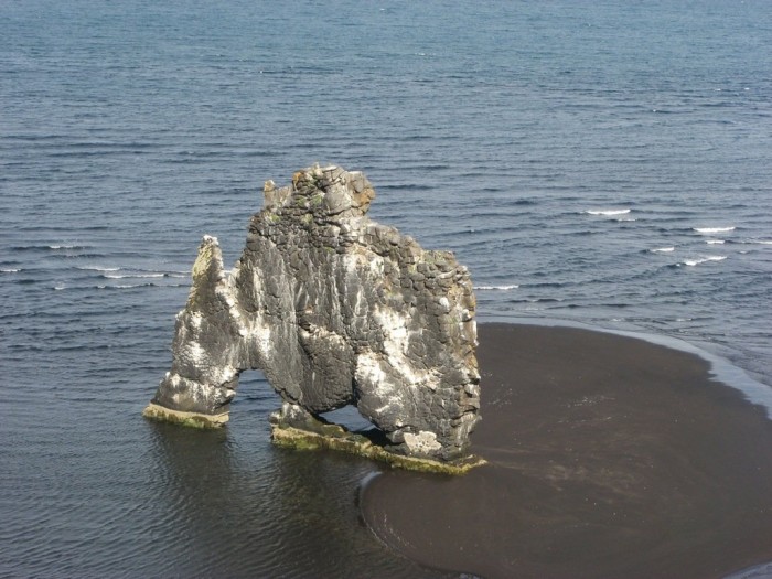Hvitserkur is a stone dinosaur at a watering hole in Iceland