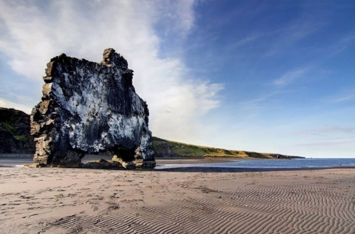 Hvitserkur is a stone dinosaur at a watering hole in Iceland