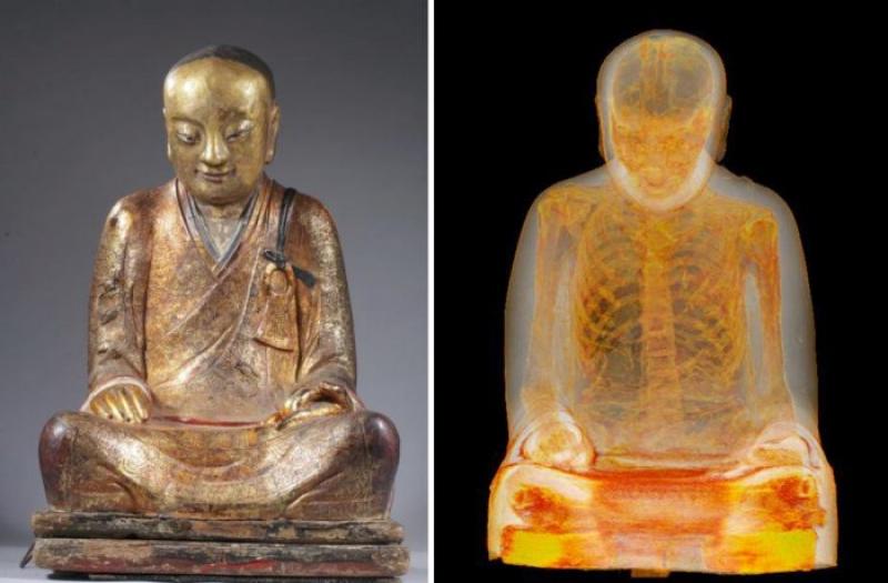 Monk inside 1000-year-old statue of Buddha