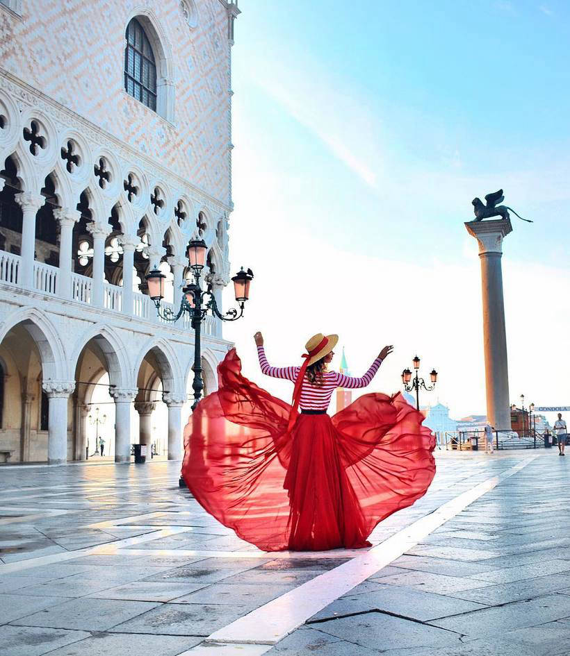 A girl travels the world in wonderful dresses and takes a photo in the most beautiful places