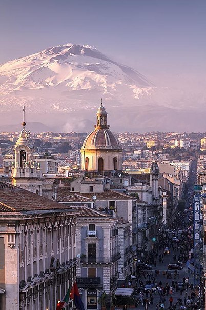 The port city of Catania in the background of the volcano Etna, Sicily, Italy