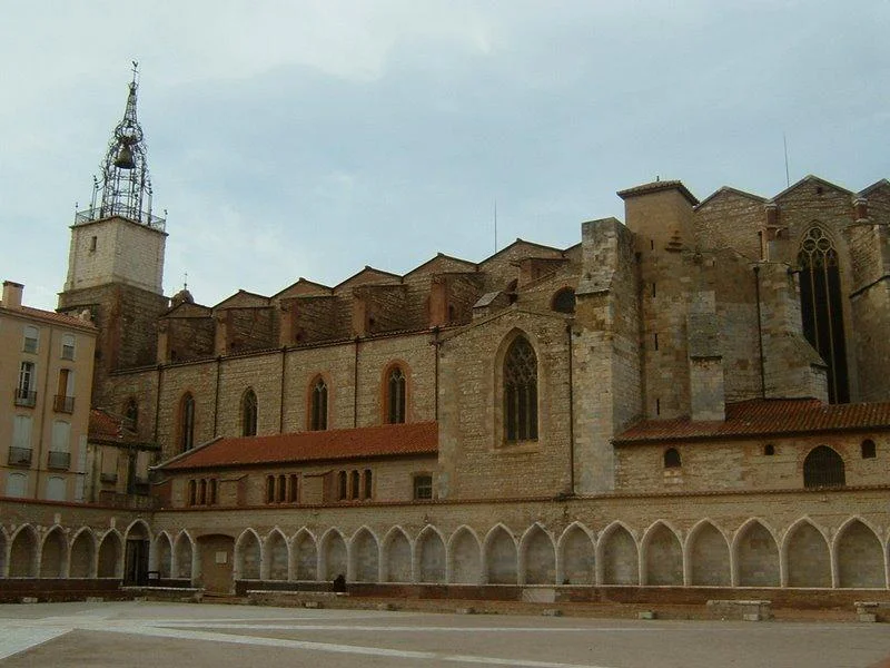 The Gothic Saint John Cathedral, with its narrow spire 68 meters tall and red roof, and the square in front of the entrance