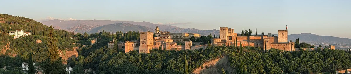 Panoramic view of the Alhambra and Sierra Nevada from the Mirador San Nicolás at sunset