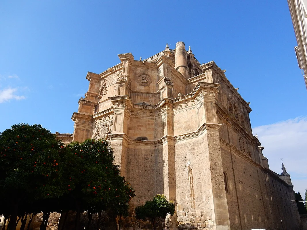 The red medieval gate of Puerta de Elvira, with its narrow passage and archway architecture